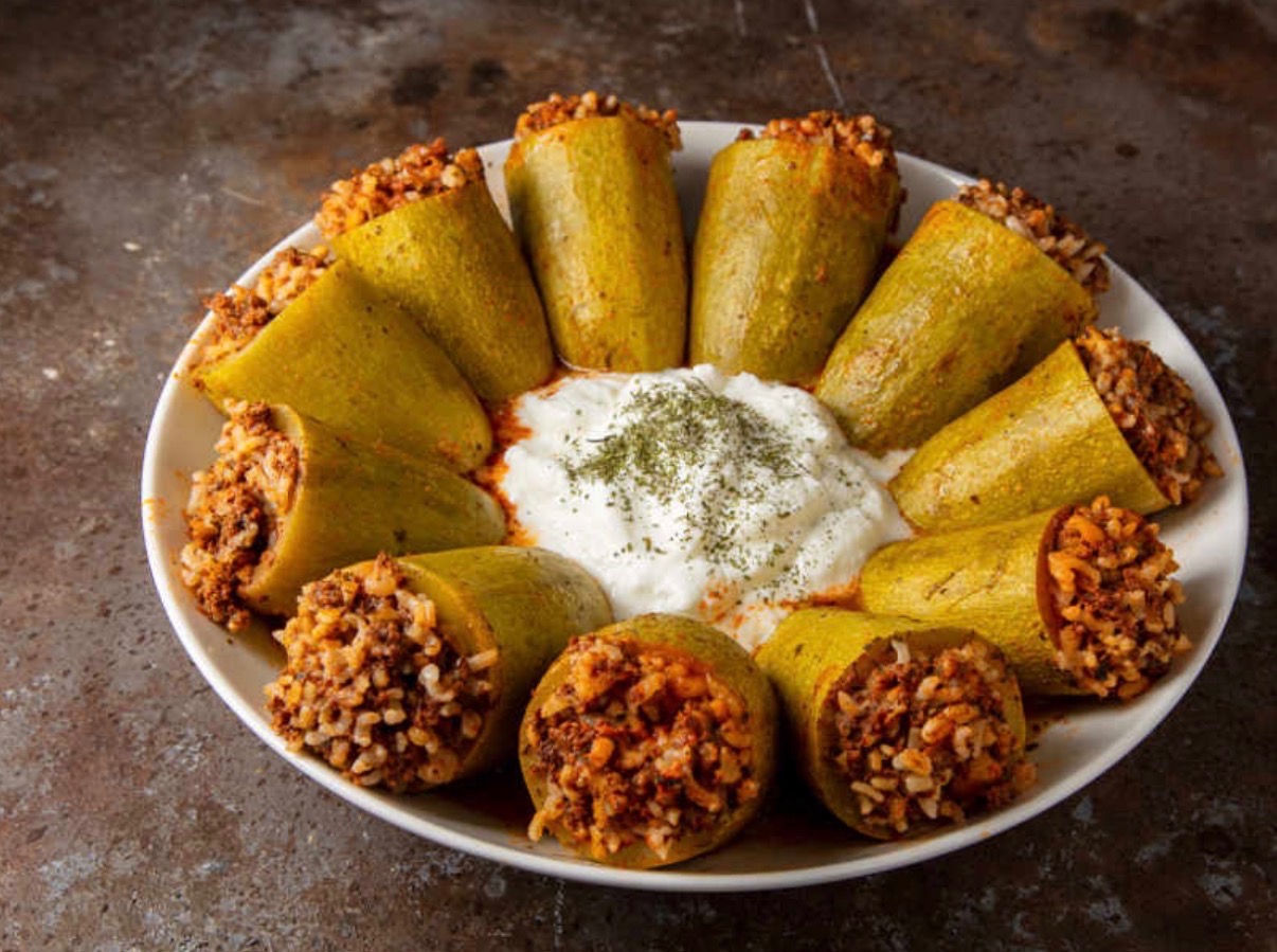 Stuffed zucchini in tomato sauce with yogurt